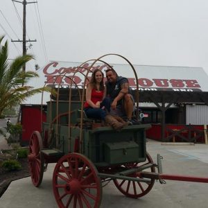a couple sitting in an old wagon
