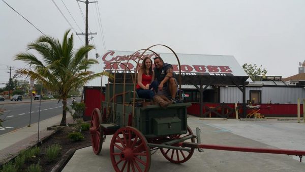 a couple sitting in an old wagon
